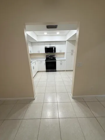 a kitchen with a stove a refrigerator and a sink
