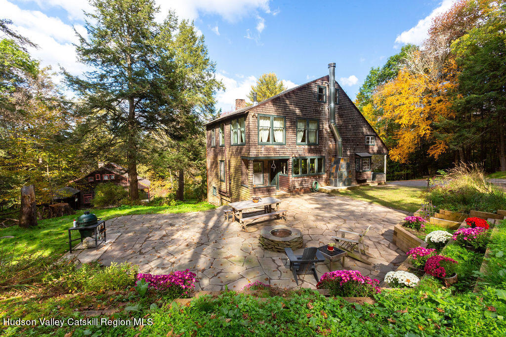 a front view of a house with yard and fountain