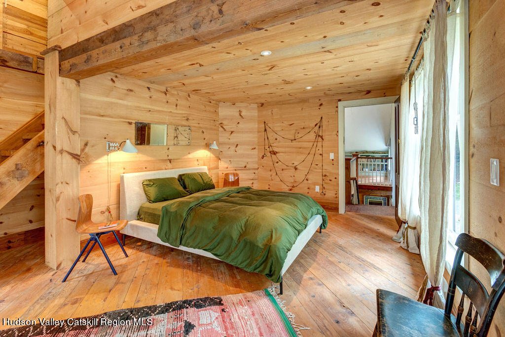 166-168 Dry Brook Road Arkville, NY 12406 - Photo 26 of 49 a bedroom with a bed and a wooden floor