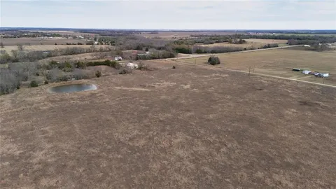 an aerial view of a houses with a lake view