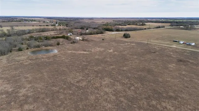 an aerial view of a houses with a lake view