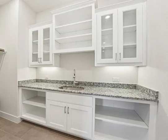 a kitchen with a stove a refrigerator and a oven