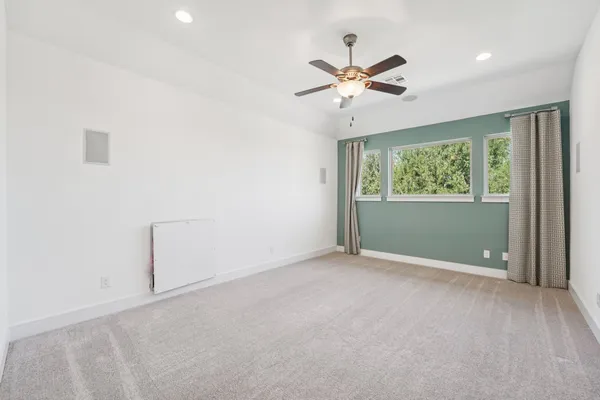 a view of wooden floor chandelier and window in a room