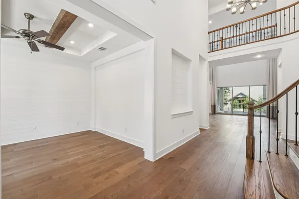 a view of a hallway with wooden floor and entryway