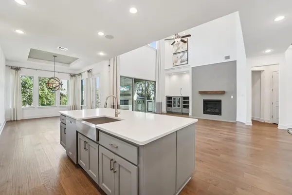 a view of empty room with wooden floor and fireplace