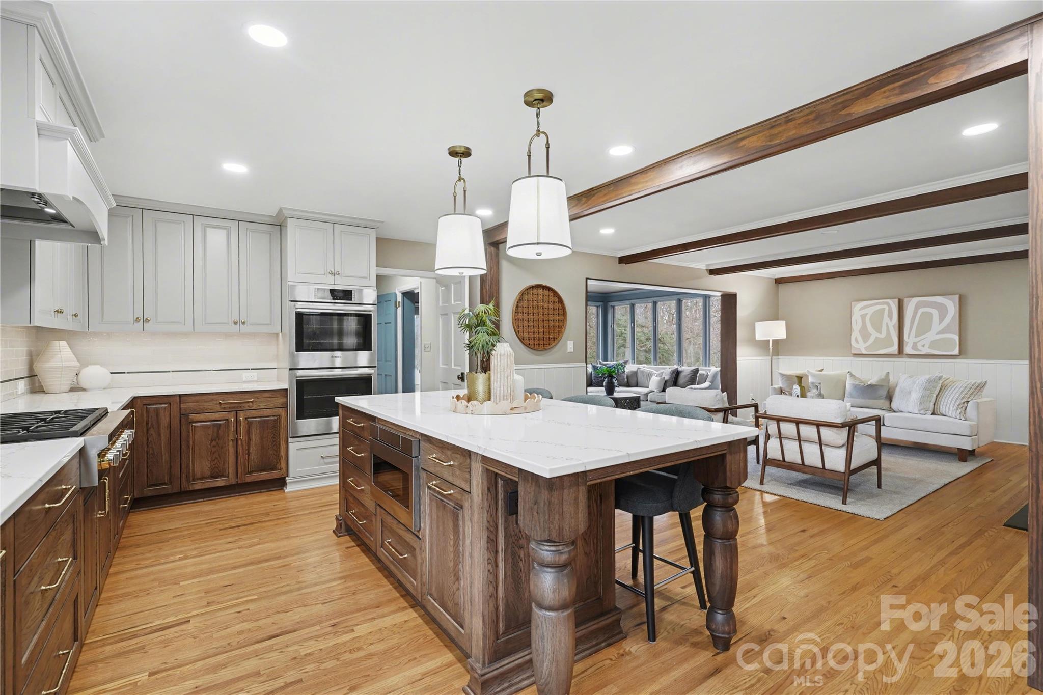 819 Ashmeade Road Charlotte, NC 28211 - Photo 11 of 42 a large kitchen with stainless steel appliances kitchen island granite countertop a stove a sink dishwasher and a dining table with the wooden floor