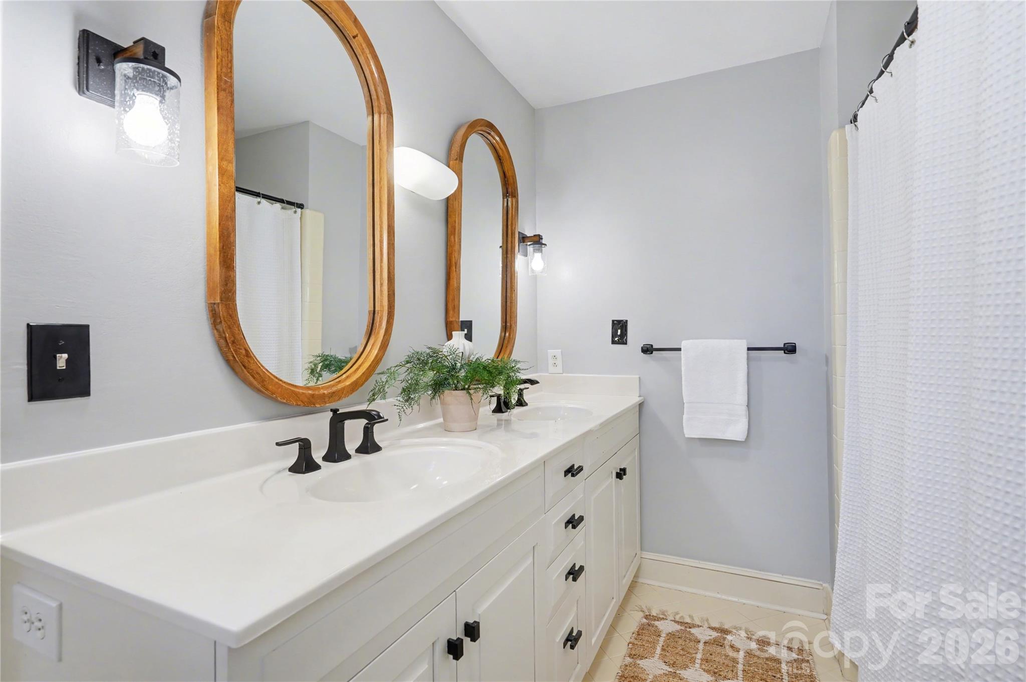 819 Ashmeade Road Charlotte, NC 28211 - Photo 26 of 42 a bathroom with a sink and a mirror