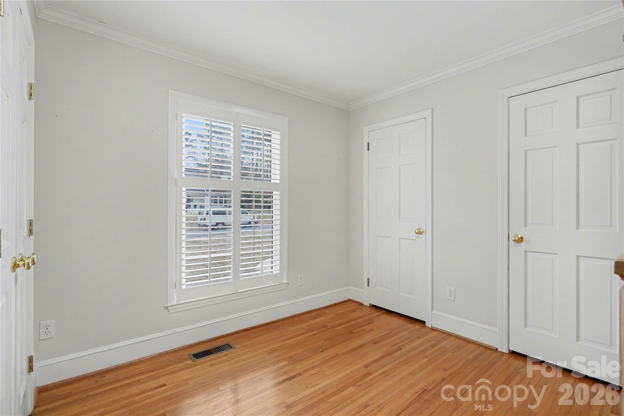 819 Ashmeade Road Charlotte, NC 28211 - Photo 27 of 42 a view of an empty room with wooden floor and a window