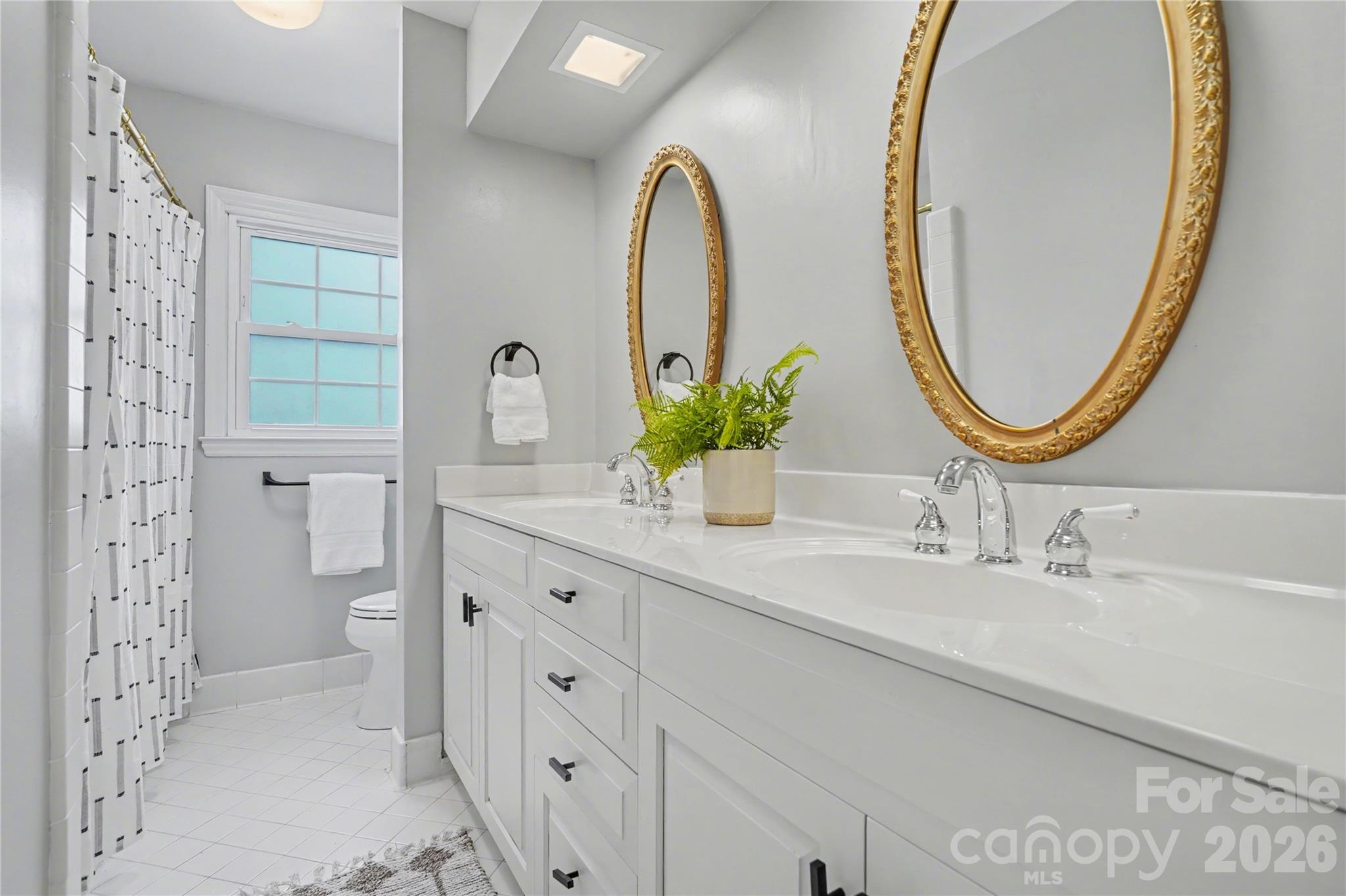 819 Ashmeade Road Charlotte, NC 28211 - Photo 29 of 42 a bathroom with a double vanity sink and a mirror