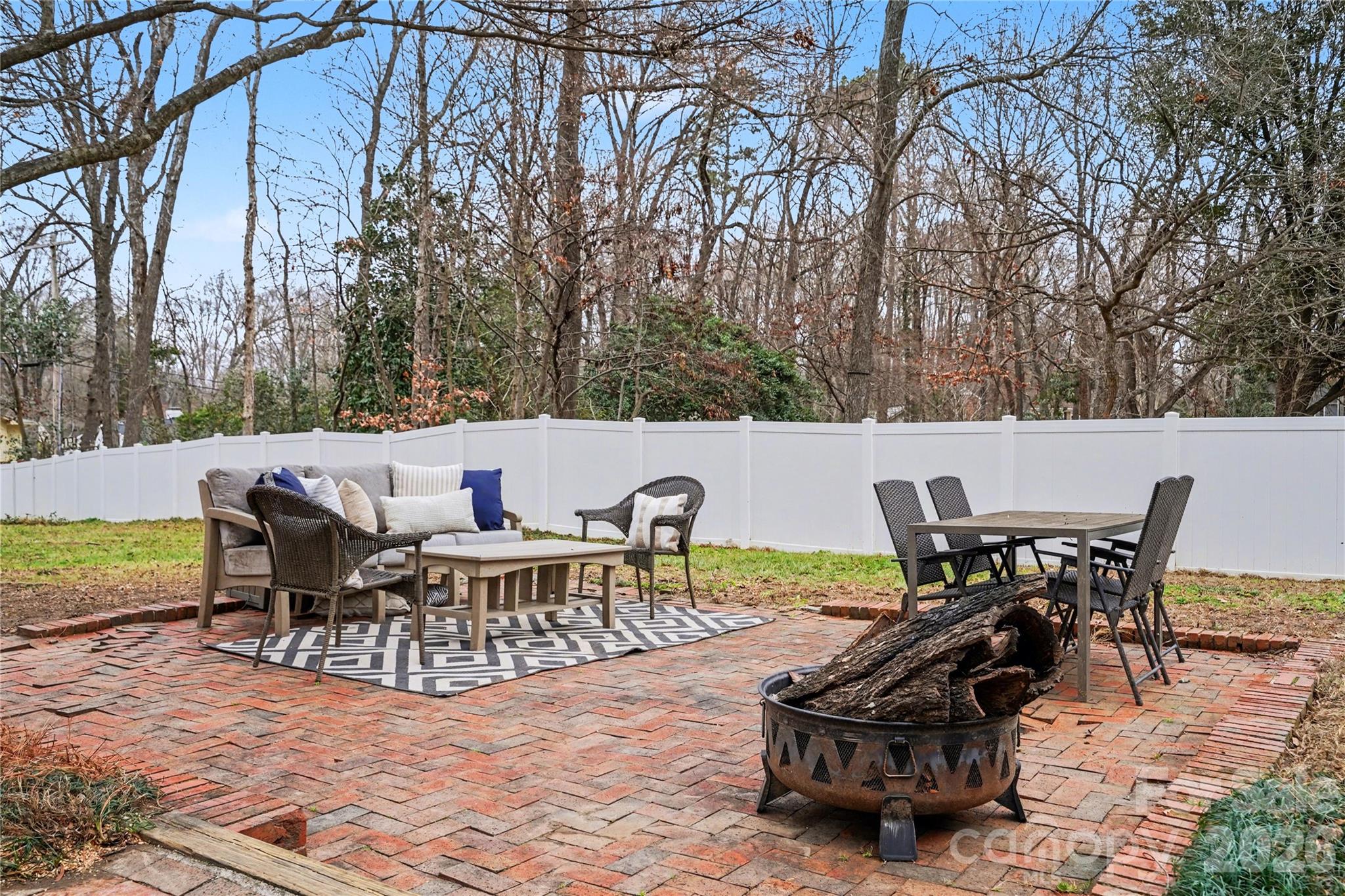 819 Ashmeade Road Charlotte, NC 28211 - Photo 36 of 42 a view of a patio with table and chairs and floor to ceiling window