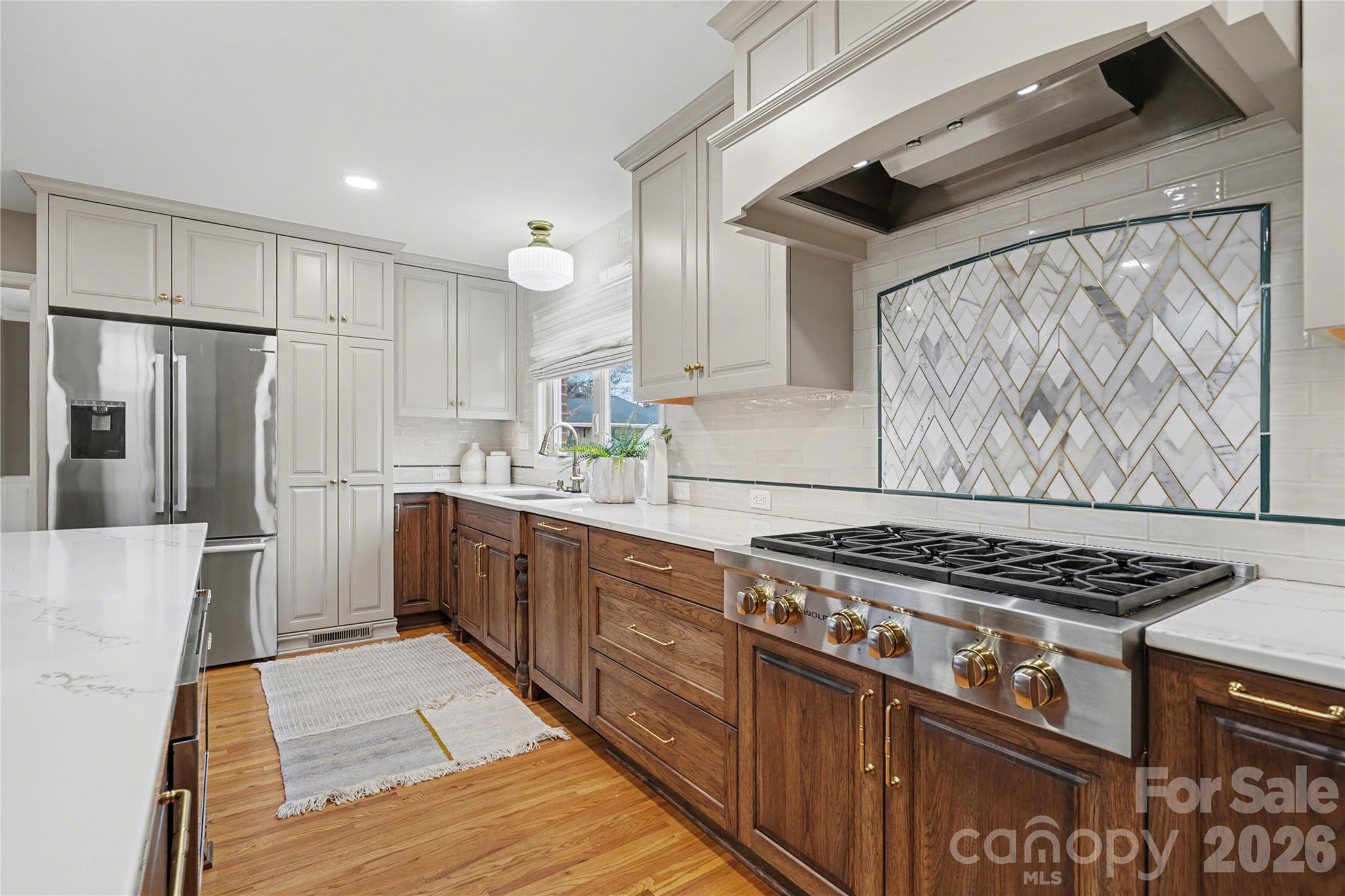 819 Ashmeade Road Charlotte, NC 28211 - Photo 10 of 42 a kitchen with stainless steel appliances granite countertop a stove and a refrigerator