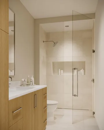 a bathroom with a shower sink vanity and toilet