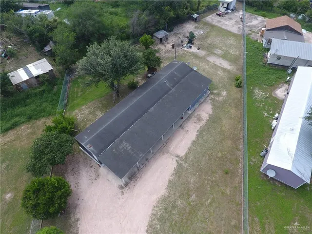 an aerial view of a house with outdoor space