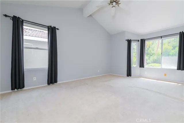an empty room with windows and closet