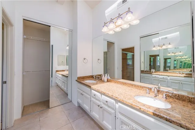a large bathroom with a large mirror vanity and a shower