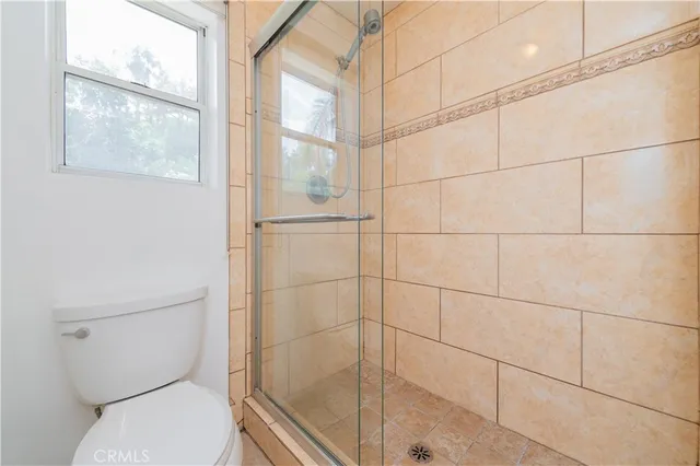 a spacious bathroom with a granite countertop sink a mirror and a bathtub