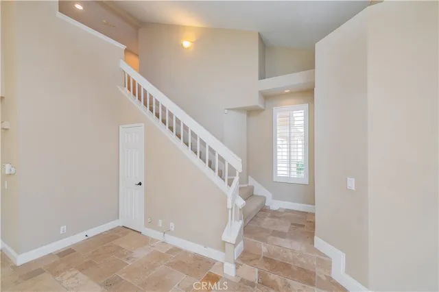 a view of a patio with a table and chairs under an umbrella