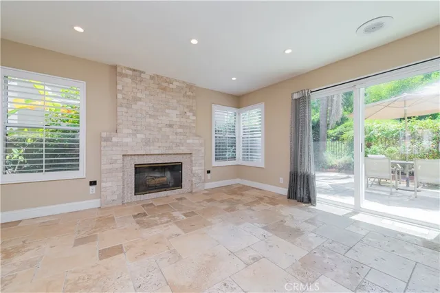 a view of an empty room with a fireplace and a large window