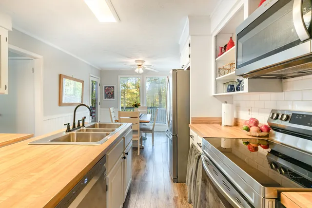 a kitchen with sink stove and cabinets