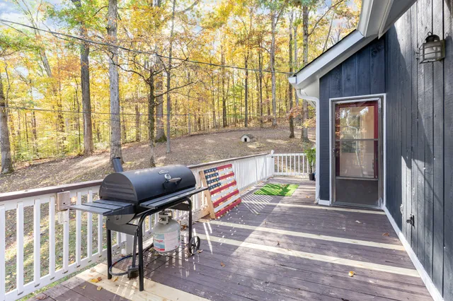 a backyard of a house with table and chairs