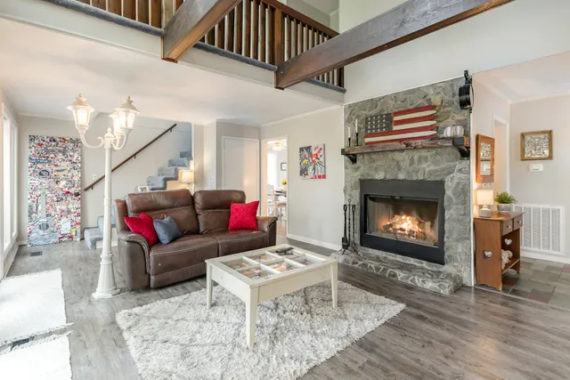 a living room with furniture and a fireplace