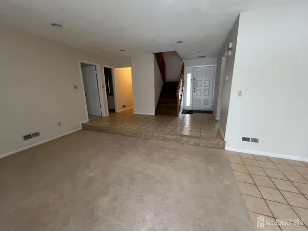 a view of a livingroom with an empty space and a window