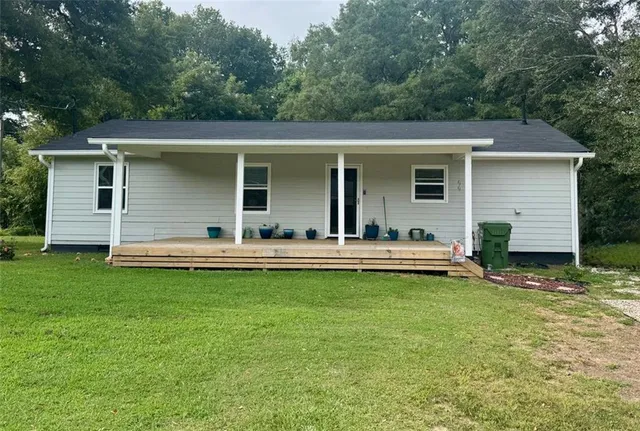 a view of a white house with a swimming pool