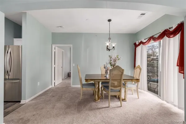 a dining room with furniture window and outside view