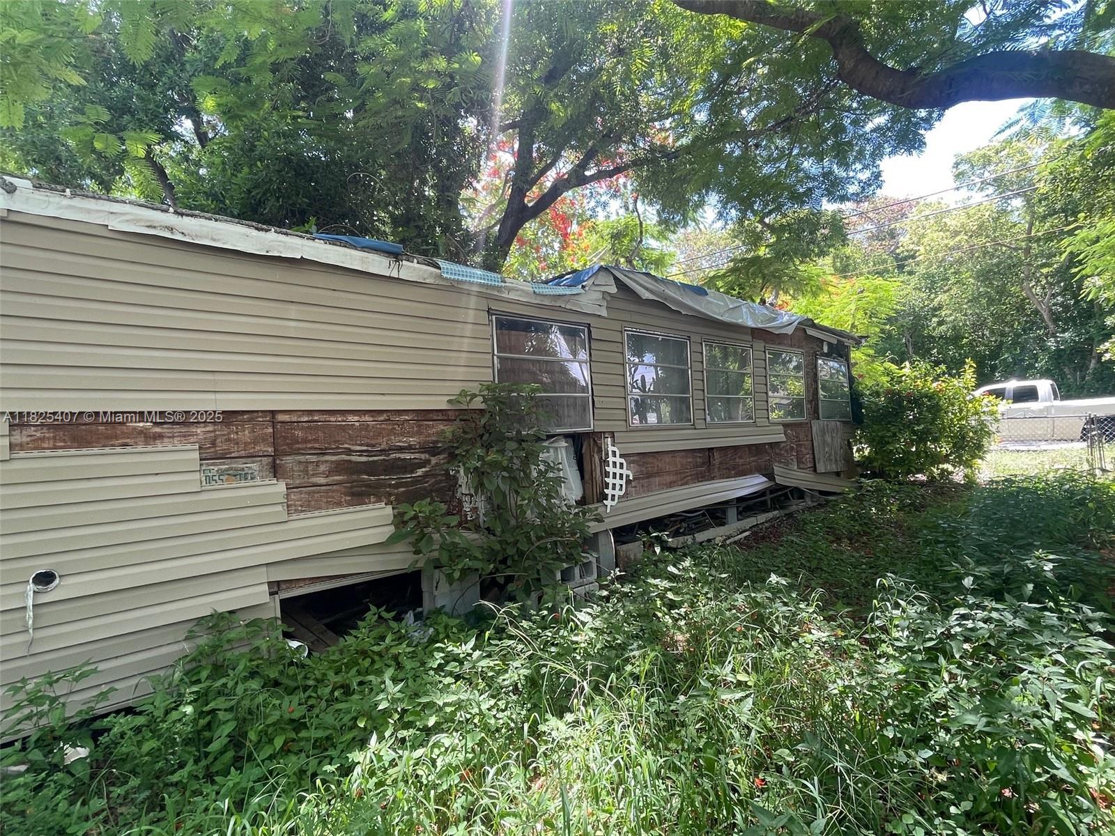 Lake Surprise Estates Key Largo, FL 33037 - Photo 5 of 6 a view of a back yard of the house