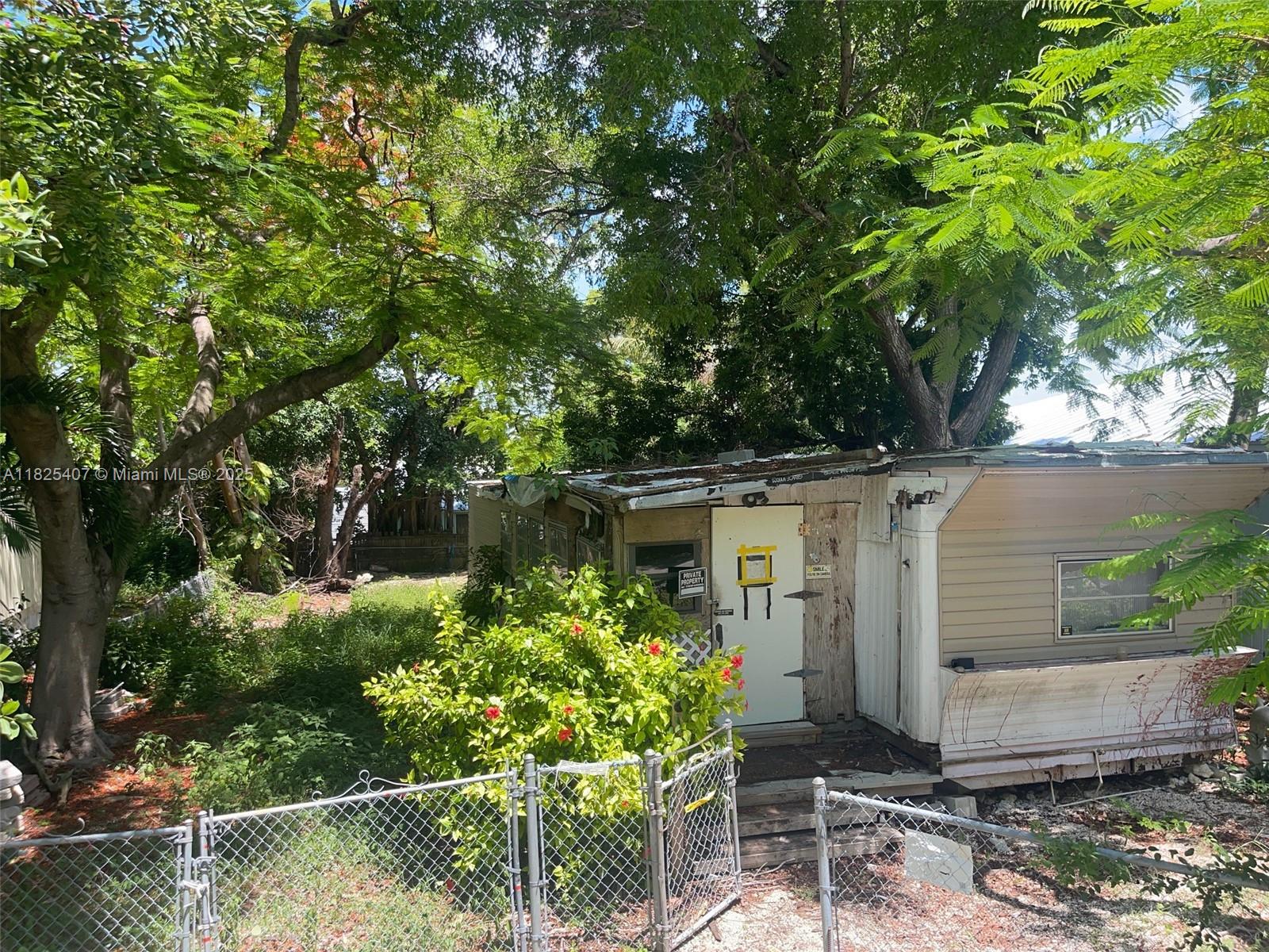 Lake Surprise Estates Key Largo, FL 33037 - Photo 6 of 6 front view of a house with a yard