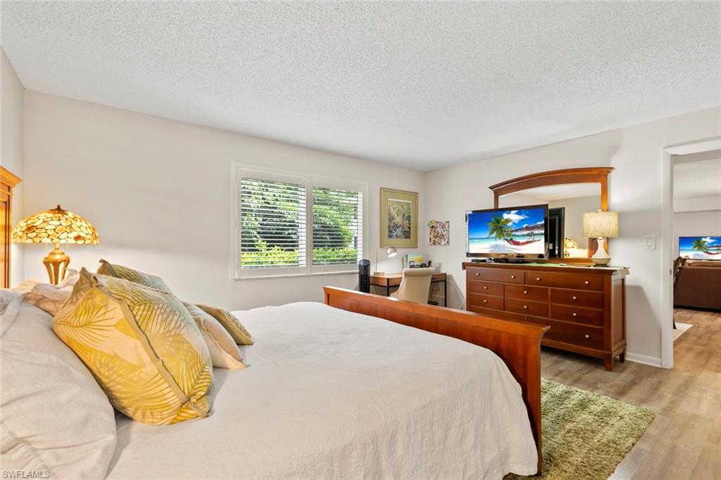 500 Teryl Road, Unit 1 Naples, FL 34112 - Photo 14 of 20 a bed room with a bed and a view of kitchen