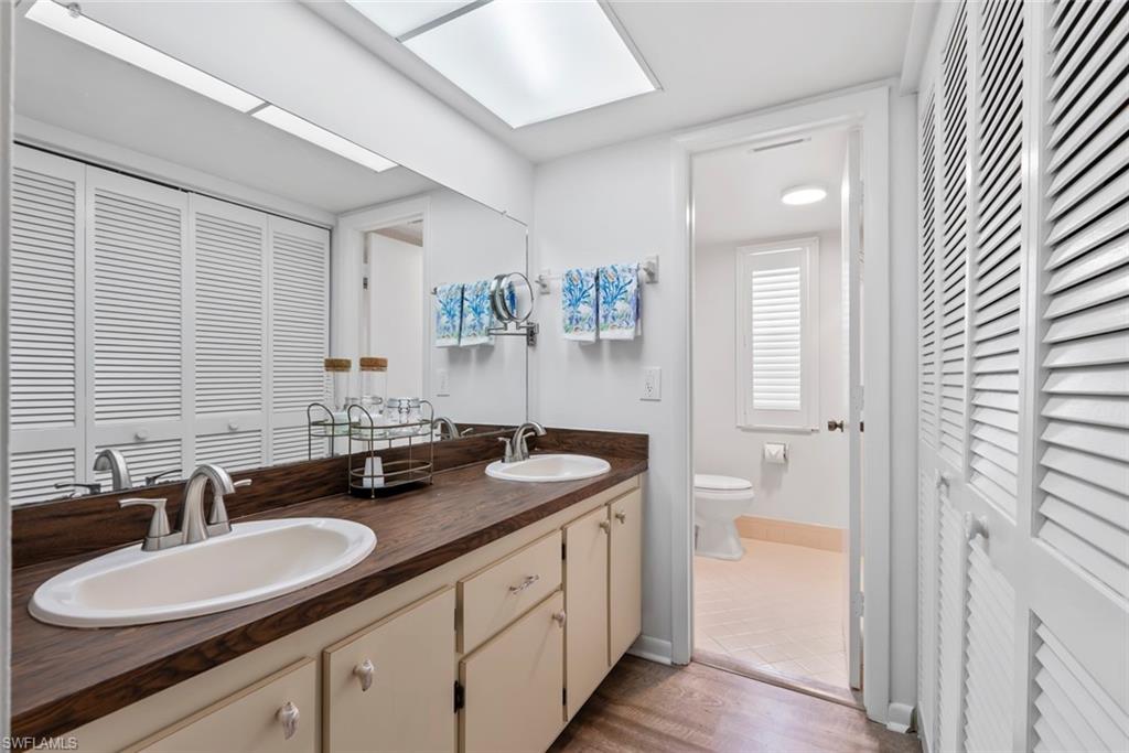 500 Teryl Road, Unit 1 Naples, FL 34112 - Photo 15 of 20 a bathroom with a double vanity sink and a mirror