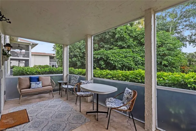 a view of a patio with a table chairs and backyard