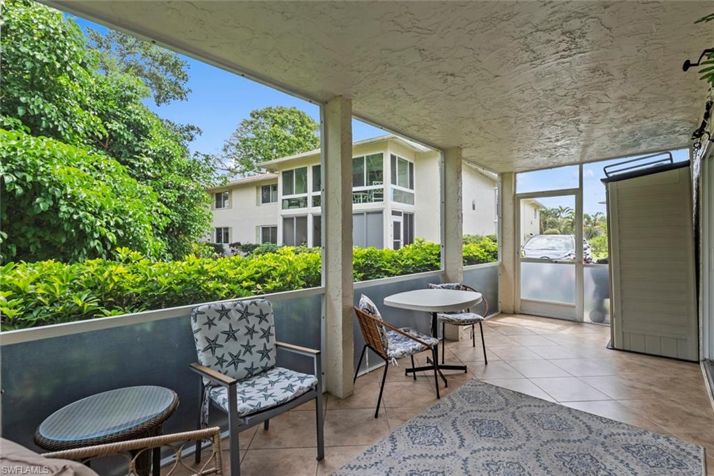 500 Teryl Road, Unit 1 Naples, FL 34112 - Photo 19 of 20 a outdoor dining space with furniture and a potted plant
