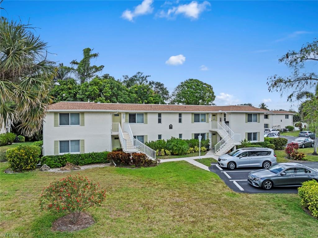 500 Teryl Road, Unit 1 Naples, FL 34112 - Photo 2 of 20 a view of a house with backyard sitting area and garden