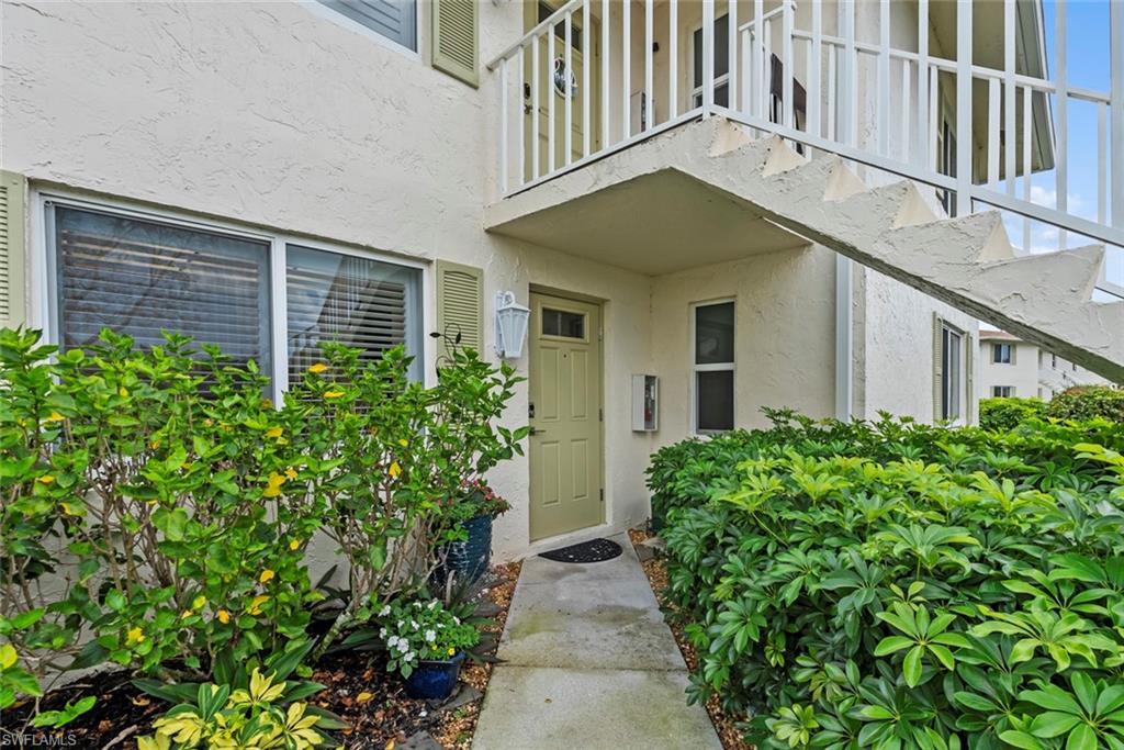 500 Teryl Road, Unit 1 Naples, FL 34112 - Photo 3 of 20 front view of a house with a yard