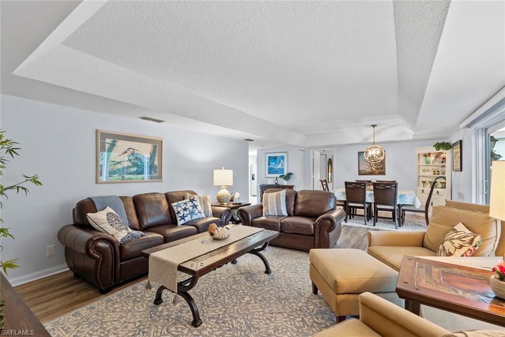 500 Teryl Road, Unit 1 Naples, FL 34112 - Photo 5 of 20 a living room with furniture a rug and a window