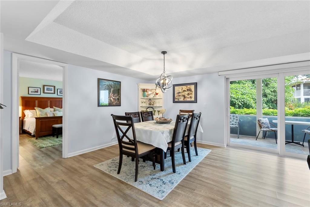 500 Teryl Road, Unit 1 Naples, FL 34112 - Photo 9 of 20 a view of a dining room with furniture window and wooden floor