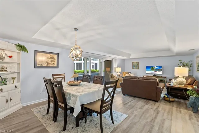 a view of a dining room with furniture and window