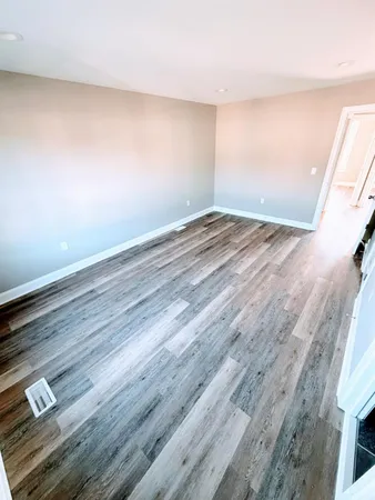 an empty room with wooden floor