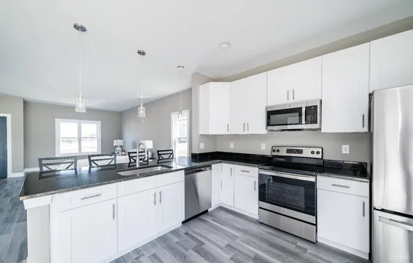 a white kitchen with stainless steel appliances