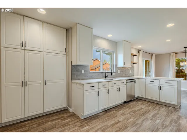 a view of a kitchen with sink cabinets and window