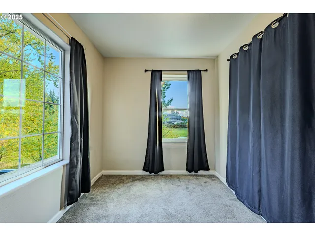a view of empty room with floor to ceiling windows