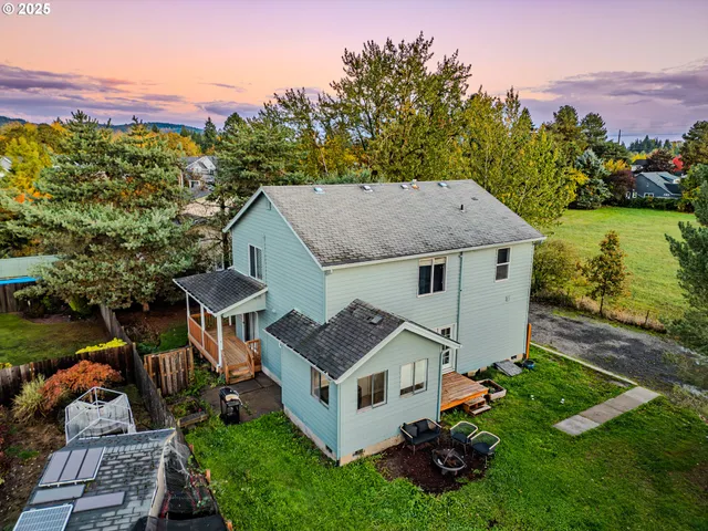 an aerial view of a house with swimming pool garden and mountain view in back