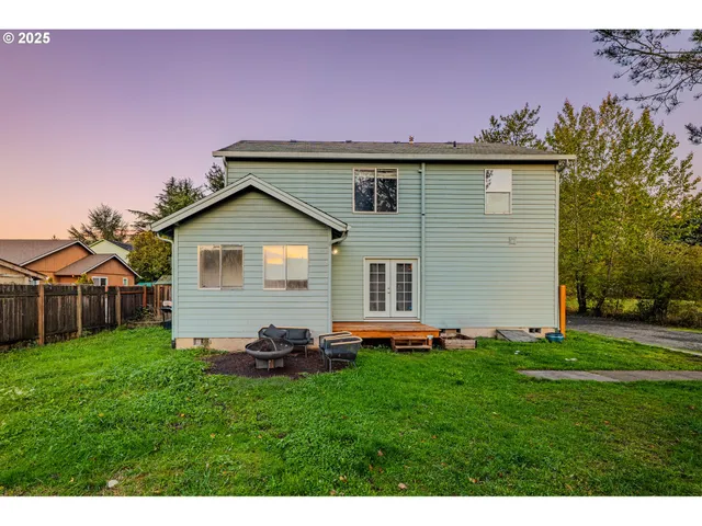 a view of a house with a yard and sitting area