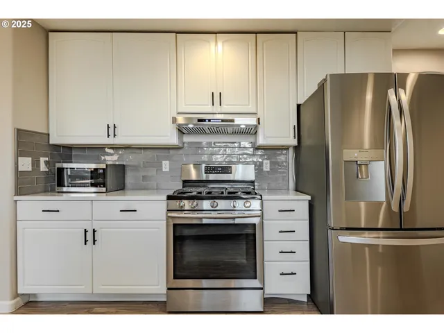 a kitchen with stainless steel appliances wooden cabinets and a counter top