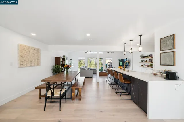 a large kitchen with a table and chairs