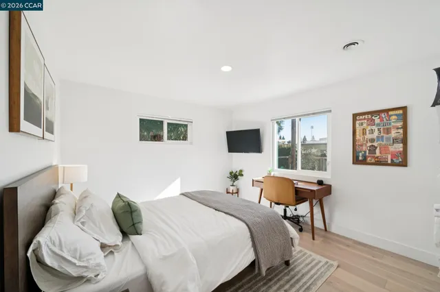 a bedroom with a bed and a chair