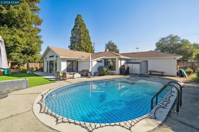 a view of a patio with a table and chairs