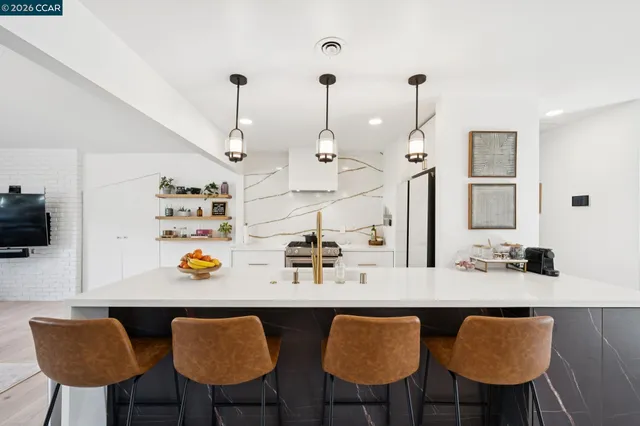 a kitchen with a dining table chairs and chairs